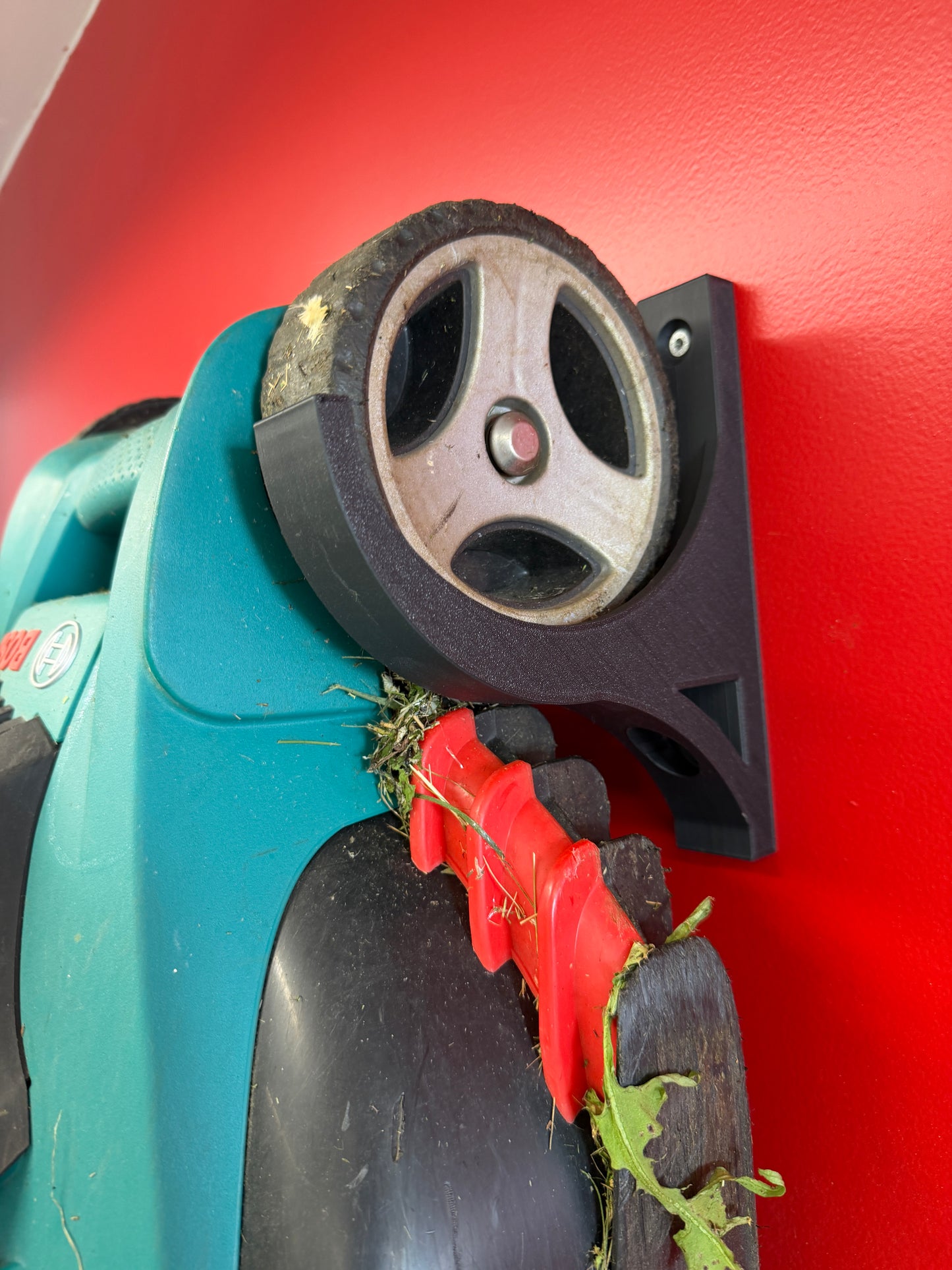 Veggfeste for batteridrevne gressklipppere